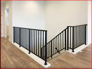 Stairway featuring hardwood / wood-style floors