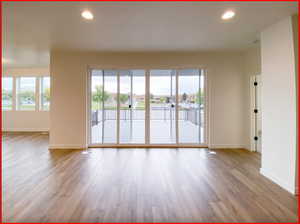 Empty room featuring a wealth of natural light and light hardwood / wood-style floors