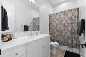 Full Guest Bathroom featuring vanity, toilet, wood-type flooring