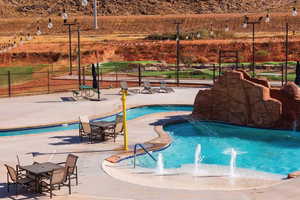 View of swimming pool with pool water feature and a patio area