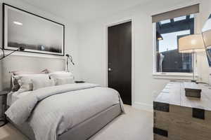 Bedroom featuring light colored carpet