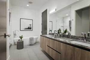 Bathroom featuring tile patterned floors, vanity, and independent shower and bath