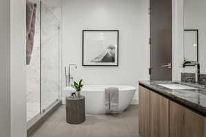 Bathroom featuring separate shower and tub, tile patterned flooring, and vanity