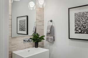 Bathroom with decorative backsplash and tile walls