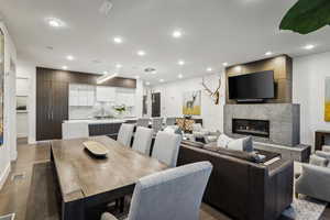 Dining area featuring a high end fireplace and dark wood-type flooring