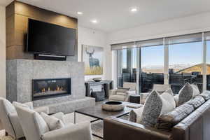 Living room with a mountain view and a tile fireplace