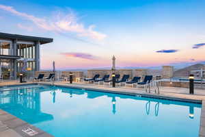 Pool at dusk with a patio