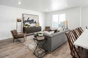 Living room featuring a textured ceiling and hardwood / wood-style flooring