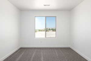 Carpeted empty room featuring a textured ceiling