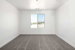 View of carpeted spare room