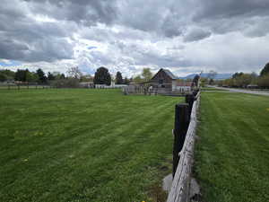 View of yard with a rural view and an outdoor structure