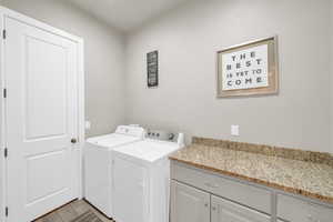 Clothes washing area with cabinets and independent washer and dryer