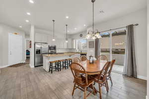 Dining space featuring an inviting chandelier and sink