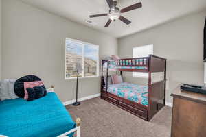 Bedroom with ceiling fan and light colored carpet