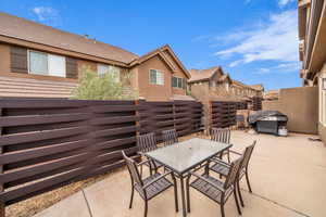 View of patio with a grill