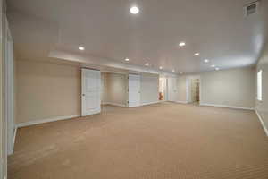 Basement with light carpet