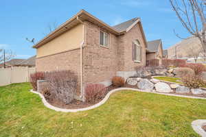 View of side of property featuring a yard