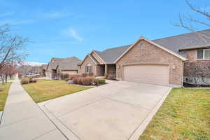 View of front of home with a garage and a front yard