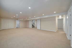 Basement with light colored carpet