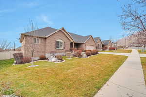 Ranch-style house with a front yard and a garage