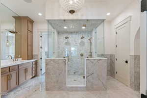 Bathroom featuring vanity, a shower with door, and tile walls