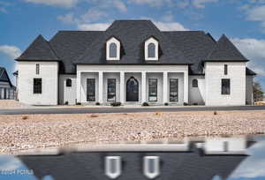 French provincial home with a porch