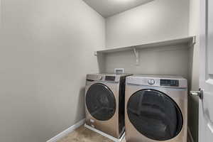 Clothes washing area with a textured ceiling and washing machine and clothes dryer