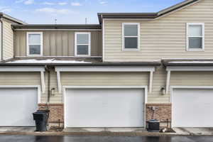 View of front facade featuring central AC and a garage