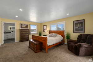 Carpeted bedroom featuring connected bathroom