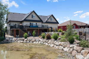 Back of property with a deck with water view