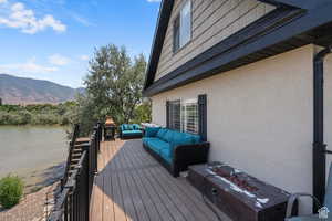 Deck with a water and mountain view and an outdoor hangout area