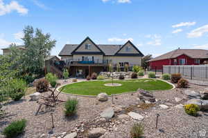 Rear view of house featuring a yard and a deck