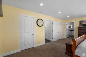 Carpeted bedroom featuring connected bathroom