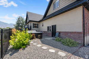 View of home's exterior with a mountain view and a jacuzzi