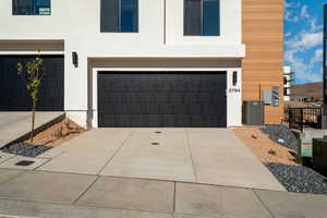 Modern home with a garage and central air condition unit