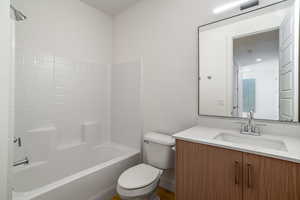 Full bathroom with shower / washtub combination, vanity, and toilet