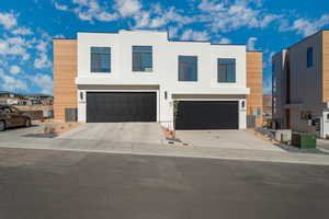 Modern home with a garage and cooling unit