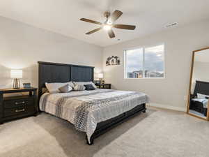 Carpeted bedroom with ceiling fan