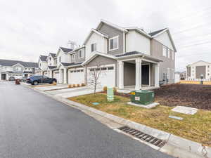 View of front of property featuring a garage and a front lawn