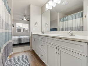 Bathroom featuring ceiling fan, hardwood / wood-style floors, and vanity