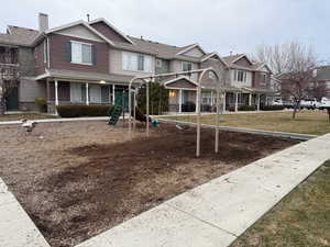 View of jungle gym with a lawn