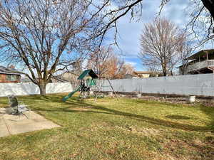 View of yard with a patio and a playground