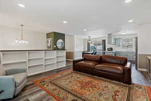 Living room featuring dark hardwood / wood-style flooring, a chandelier, a textured ceiling, and sink