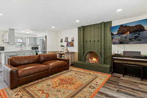 Living room with a fireplace, dark hardwood / wood-style floors, and sink