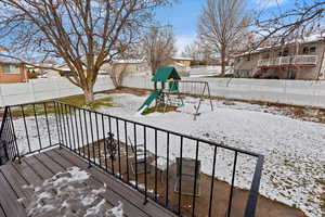 Snow covered deck with a playground