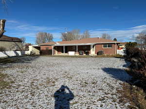 Snow covered property featuring a patio