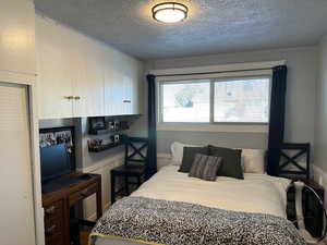 Bedroom featuring a textured ceiling