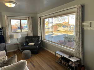 Sitting room with wood-type flooring