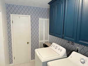 Laundry room with washing machine and dryer and cabinets