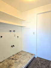 Clothes washing area featuring carpet flooring, washer hookup, hookup for an electric dryer, a textured ceiling, and gas dryer hookup